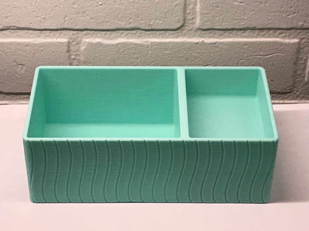 A Simple Stationairy Supplies organizer 3D printed in Cyan against a white background